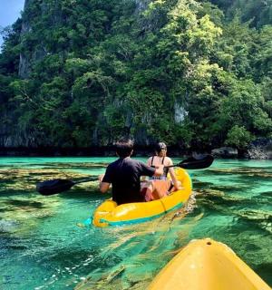 a man and a woman in a kayak in the water