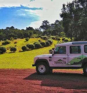 a jeep parked on a dirt road in a field