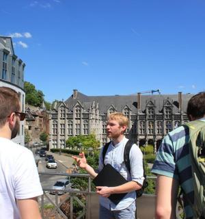 a group of men standing on top of a building
