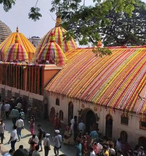 a group of people walking around a building with a crowd
