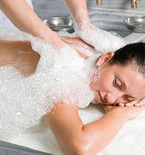 a woman in a bathtub covered in sugar