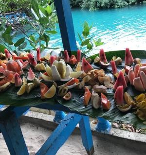 a bunch of flowers on a table next to the water