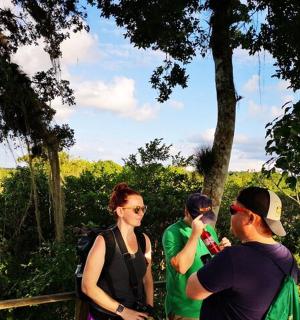 a group of people standing next to a fence