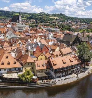 an aerial view of a town next to a river