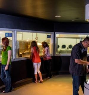 a group of people standing in front of a museum