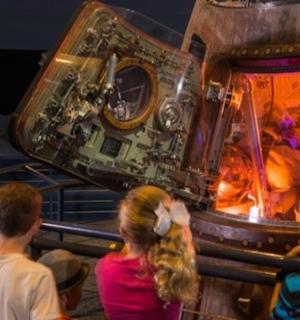 a group of people looking at a space station