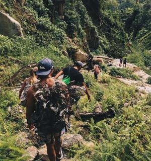 a group of people walking on a mountain trail