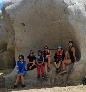 a group of people sitting in a rock formation