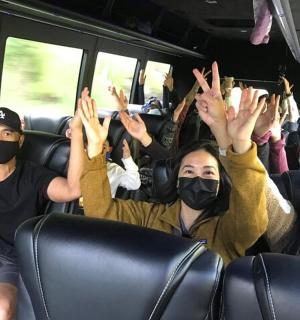 a group of people on a bus wearing masks