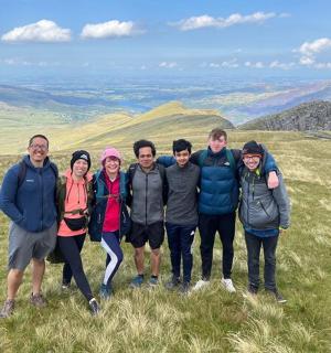 a group of people standing on top of a hill