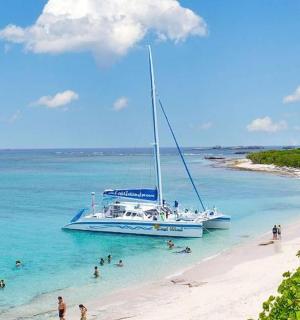 a boat on a beach with people in the water