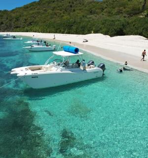 a boat in the water next to a beach