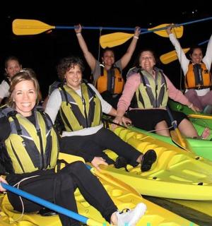 a group of people sitting on kayaks in the water
