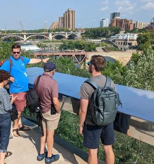 a group of people standing on a bridge