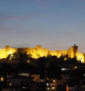 a large castle is lit up at night