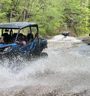 an atv driving through a stream of water