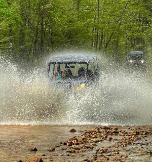a car is driving through a water logged road