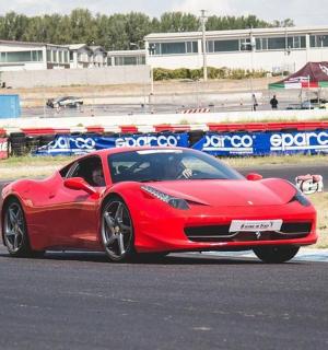 a red car driving on a race track
