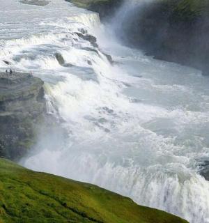a large waterfall on the side of a river
