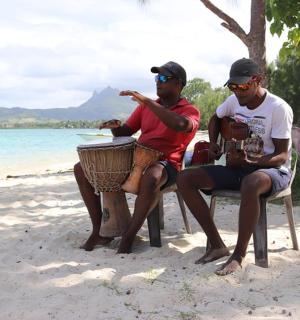 两个男人坐在海滩的长椅上