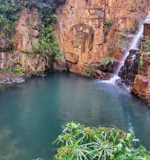 a pool of water in front of a waterfall