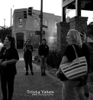 skupina lidí stojících na rohu ulice