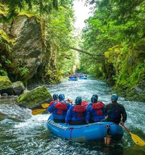 a group of people in a raft in a river