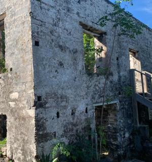 an old stone building with a staircase on the side