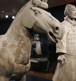 a statue of a man standing next to a horse