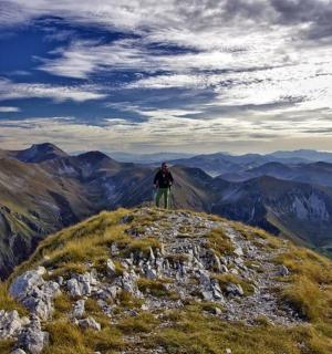 a man standing on the top of a mountain