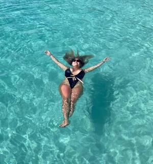 a woman is swimming in the clear water