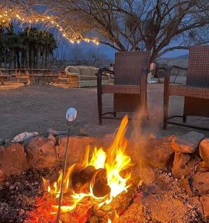 a fire pit with two chairs sitting around it