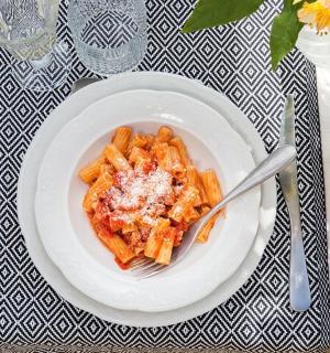a plate of pasta on a table with a fork