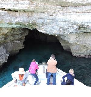 a group of people on a boat in a cave