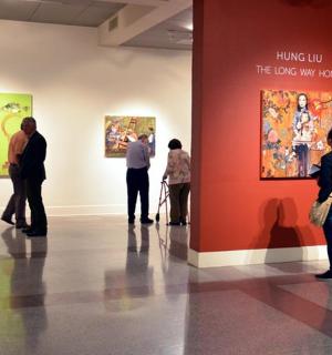 a group of people looking at art in a museum