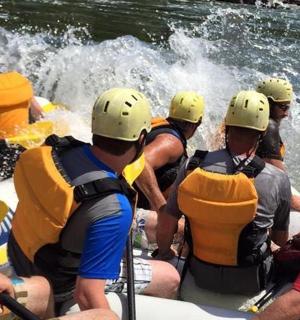 a group of people in a raft in the water