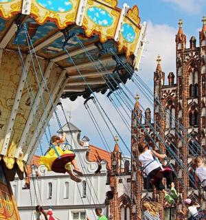 a merry go round with people riding on a carousel
