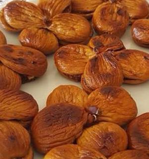 a pile of nuts sitting on a white plate