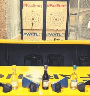 a yellow table with bottles of wine on it