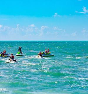 a group of people riding on surfboards in the ocean
