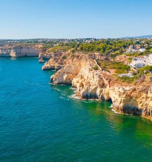 an aerial view of a rocky island in the ocean