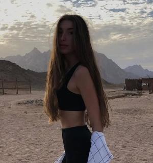 a woman in a black dress standing in the desert