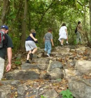 a group of people walking down a rocky trail