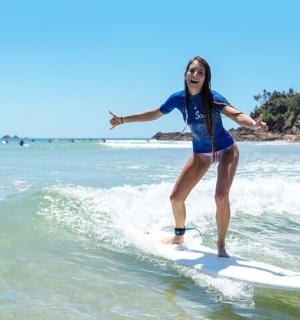 a woman riding a wave on a surfboard in the ocean
