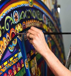 a person painting a wall with a paintbrush