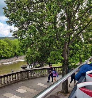 a group of people on a bus looking at a river