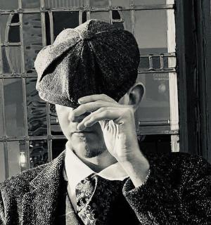 a man wearing a hat is talking on a cell phone