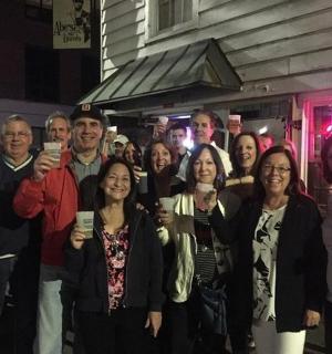 a group of people posing for a picture with their cell phones