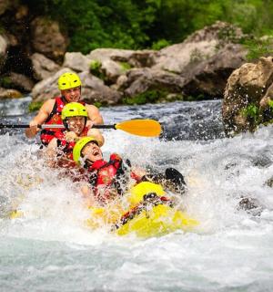 a group of people in a raft in a river