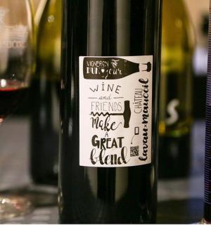 a bottle of wine next to a glass of wine